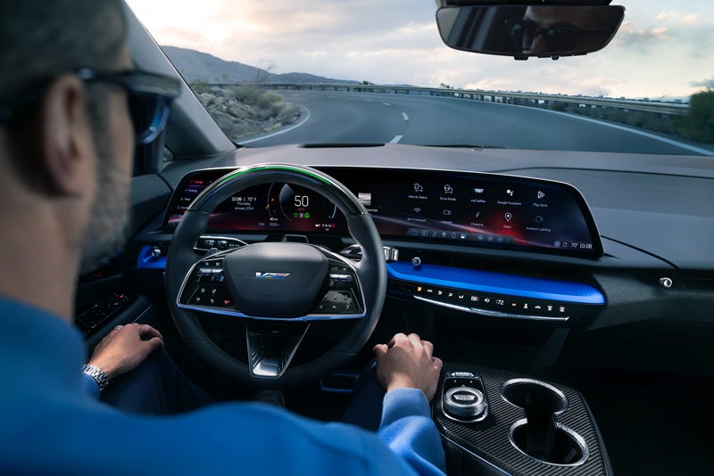 Front View of the 2026 OPTIQ-V Driving Through the Dusk Utilizing its Headlights | Opequon Motors in Martinsburg WV